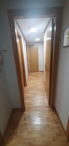 a hallway of a room with wooden floors and doors at Rooms Suite Planetario in Madrid