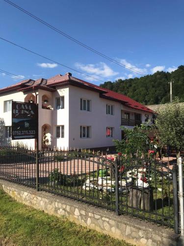 a building with a fence in front of it at Casa Irina in Mănăstirea Humorului