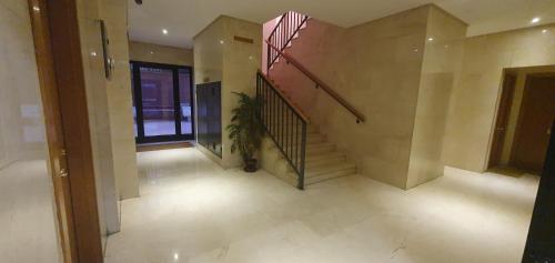 an empty hallway with a staircase in a house at Rooms Suite Planetario in Madrid
