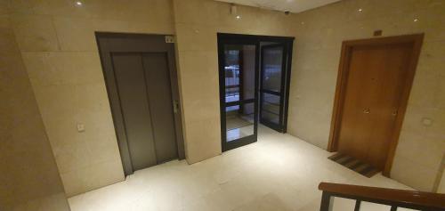an empty room with two doors in a building at Rooms Suite Planetario in Madrid