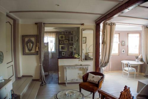 a living room with a chair and a fireplace at VILLA VOLUBILIS in Monserrat