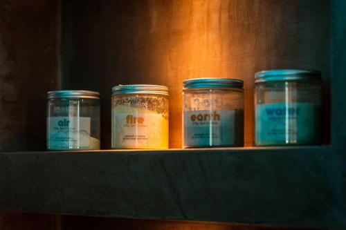 four jars of food sitting on a shelf at THE miniPENTHOUSE terrace & SPA in Paço de Arcos