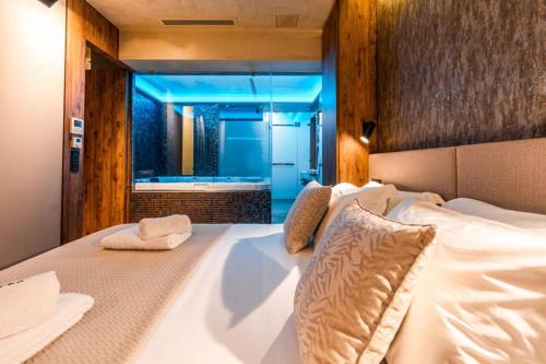 a bedroom with a large white bed in a room at THE miniPENTHOUSE terrace & SPA in Paço de Arcos