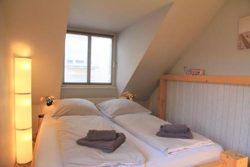 a bed with two pillows on it in a attic at ruhige gemütliche 2Z-Whg in S-West in Stuttgart