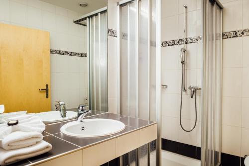 a bathroom with a sink and a shower at flexymotel Buchs in Buchs