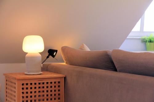 a living room with a couch and a lamp on a table at ruhige gemütliche 2Z-Whg in S-West in Stuttgart