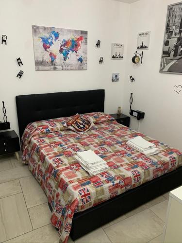 a bedroom with a bed with a quilt on it at Maison Jean-Luc - app Vittorio in Bra