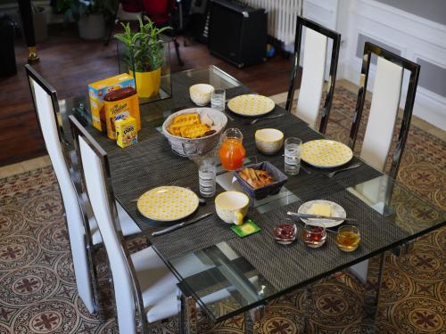 a glass table with food on top of it at Le Manoir de Louviers in Louviers