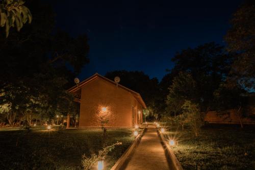 a building with lights on the side of it at night at Tranquil Wild in Tanamalwila