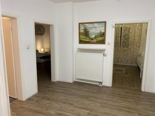 a room with a hallway with a radiator and a door at Ferienwohnung Julia in Vlotho