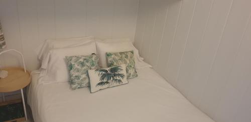 a white bed with two pillows on it at Casa do Pátio in Lisbon