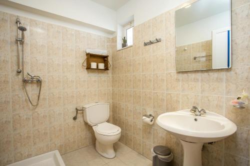 a bathroom with a toilet and a sink at Kampus Living Luxury Complex in Faliraki