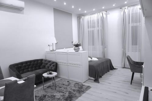 a living room with a couch and a table at Noemiz Exclusive Apartments in Budapest