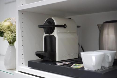 a coffee maker sitting on top of a shelf at Noemiz Exclusive Apartments in Budapest