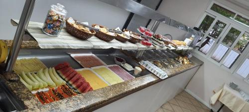 a buffet with many different types of food on display at Hotel Pousada Ilha do Mar Bombinhas in Bombinhas
