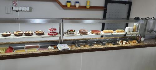 a bakery with many different types of cakes and pastries at Hotel Pousada Ilha do Mar Bombinhas in Bombinhas