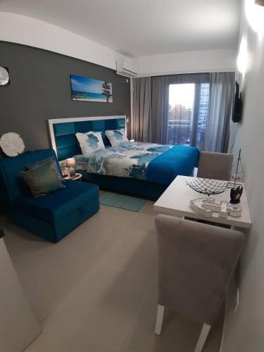 a bedroom with a bed and a couch and a table at Sea&Center Lux in Bar