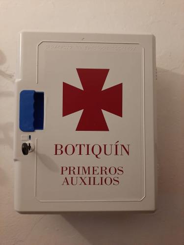 a sign on a door with a red cross on it at TIO TESORO in Los Romeros