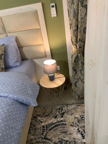 a bedroom with a bed and a lamp on a table at Sea&Center Lux in Bar