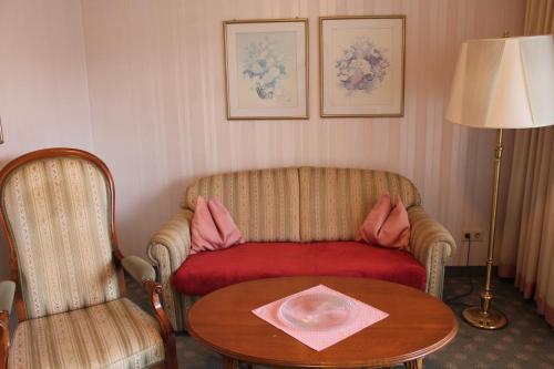 a living room with a couch and a table at Appartementhaus Wimmerhof in Bad Füssing