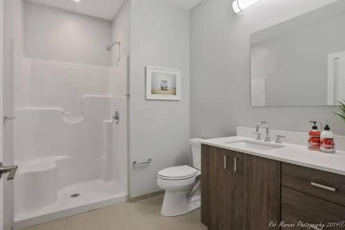 a bathroom with a shower and a toilet and a sink at Luxury Apartment W Gym, Steps From Commuter Rail #2013 in Reading