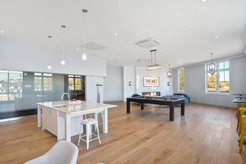 a kitchen and living room with a pool table at Luxury apartment with gym, steps from commuter rail #4011 in Reading
