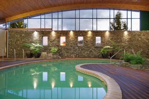 a large swimming pool in a large room at Novotel Rotorua Lakeside in Rotorua