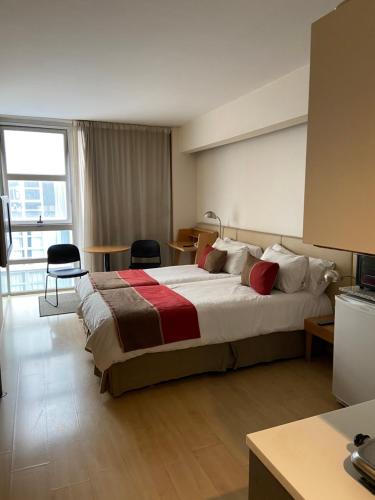 a hotel room with a large bed in a room at Recoleta Apartment in Buenos Aires