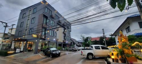 a street with a truck parked in front of a building at Debua Mahasarakham in Maha Sarakham