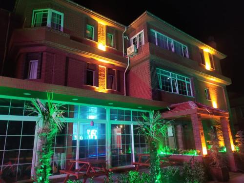 a building with lights in front of it at night at OFURO WORLD HOTEL SPA in Izmir