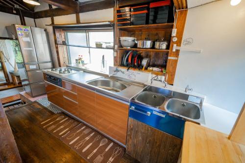 a kitchen with a sink and two sinks at Momonga Village in Miyoshi