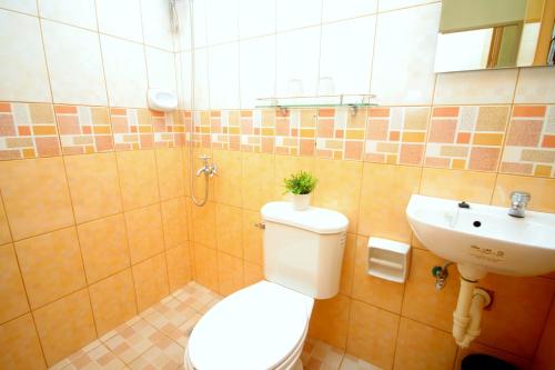 a bathroom with a toilet and a sink at Anri Pension House in Cebu City