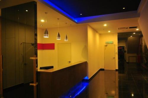 a bathroom with a sink and a blue light at Biz Hotel in Batu Pahat