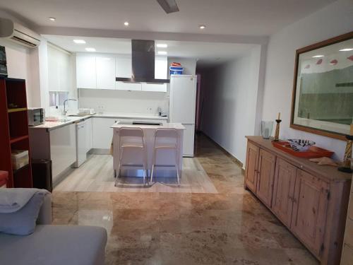 a kitchen with white cabinets and a white refrigerator at Bahia de Jávea Primera línea in Jávea