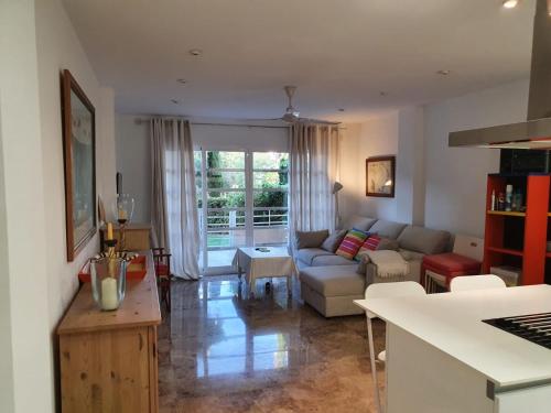 a living room with a couch and a table at Bahia de Jávea Primera línea in Jávea