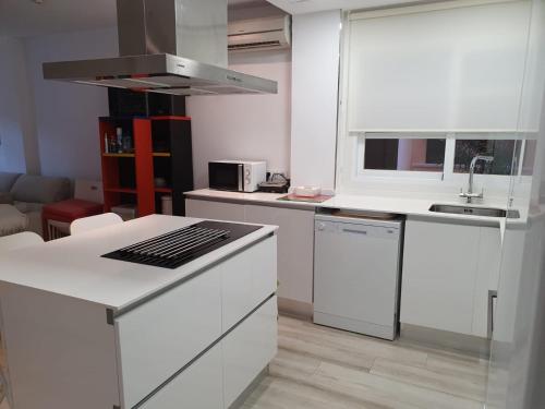a kitchen with white cabinets and a counter top at Bahia de Jávea Primera línea in Jávea