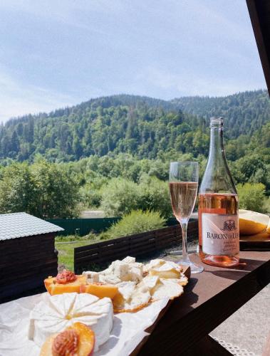 a bottle of wine and a glass on a table at Veranda in Mykulychyn