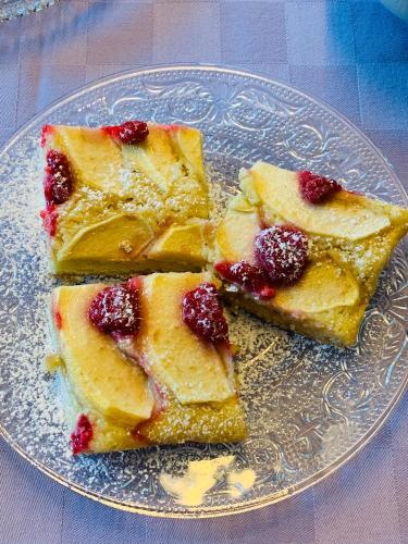 four pieces of cake on a plate on a table at B&B Beauty House in Cesena