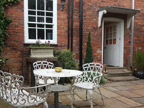 a table and two chairs and a table and a building at The Red House in Grantham