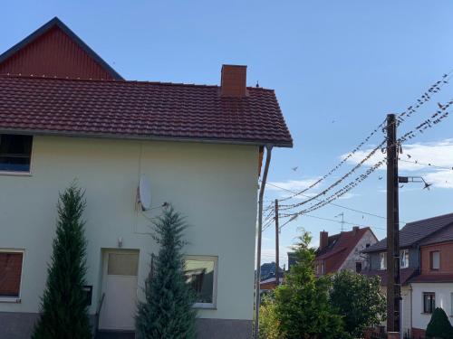a white house with a red roof at landpension-dette in Berlingerode
