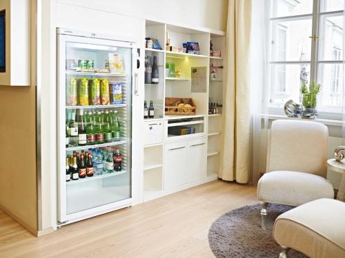 a refrigerator filled with lots of drinks in a room at Hapimag Ferienwohnungen Salzburg in Salzburg