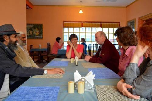 a group of people sitting around a table at Hotel Harmony in Khajurāho