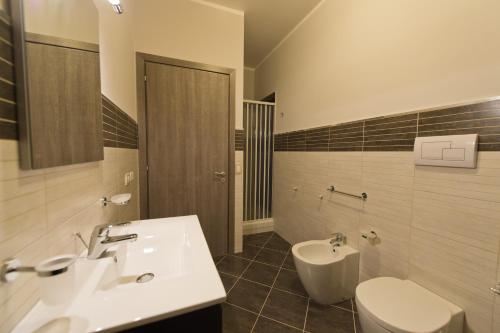 a bathroom with a sink and a toilet at Bono Vacanze Villa San Marco Luxury Holidays Homes in Sciacca