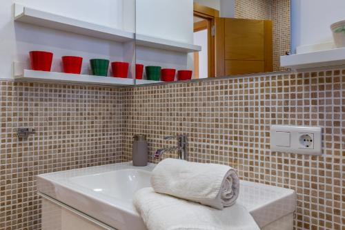 a bathroom with a white sink and a mirror at Casa Can Picarola in Santanyi