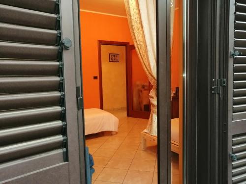 a view of a room with orange walls and a bedroom at La Casa di Laura in Ciriè