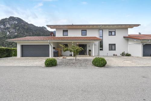 a large white house with a garage at Ferienwohnung Panorama Og in Inzell