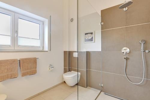 a bathroom with a shower and a toilet and a window at Ferienwohnung Panorama Og in Inzell