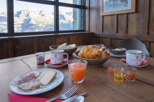a table with breakfast foods and drinks on it at Refuge du Montenvers in Chamonix-Mont-Blanc