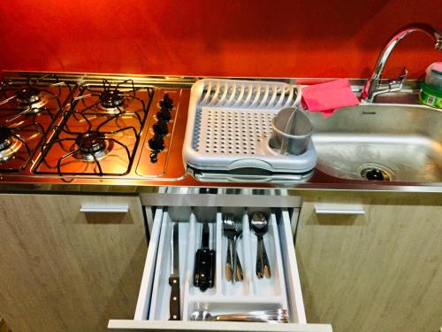a kitchen with a stove and a sink at Tokerau Tahiti in Pirae