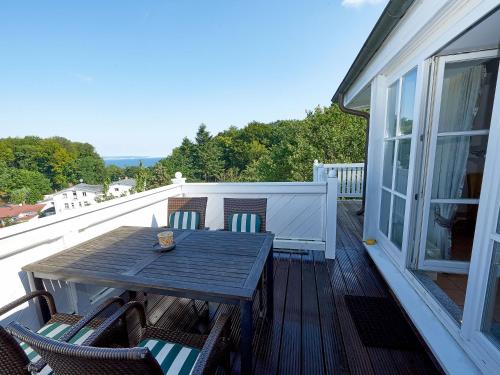 a wooden table and chairs on a balcony at Villa Granitz - Apt. 09 in Binz